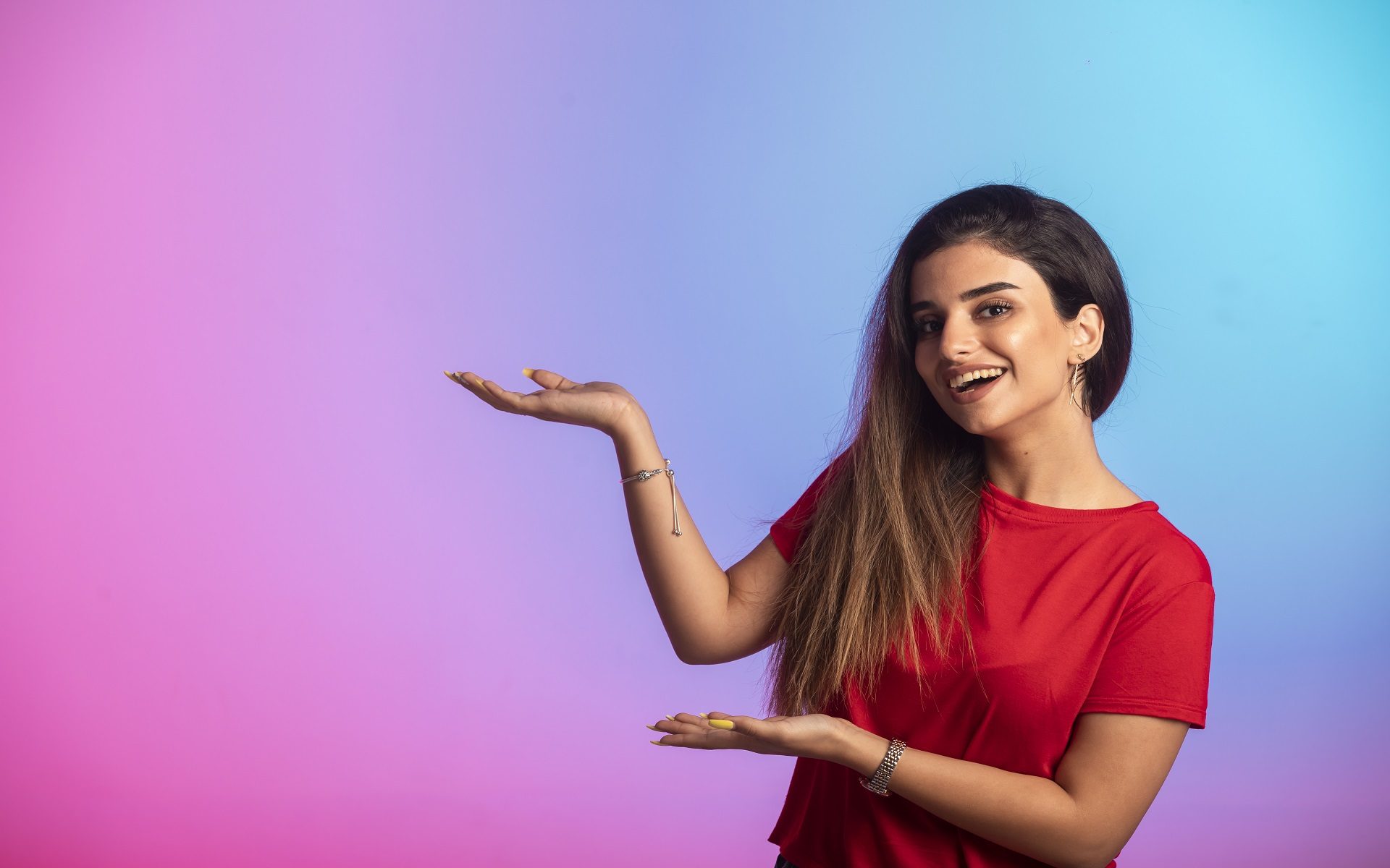 Young girl in red shirt showing something. High quality photo